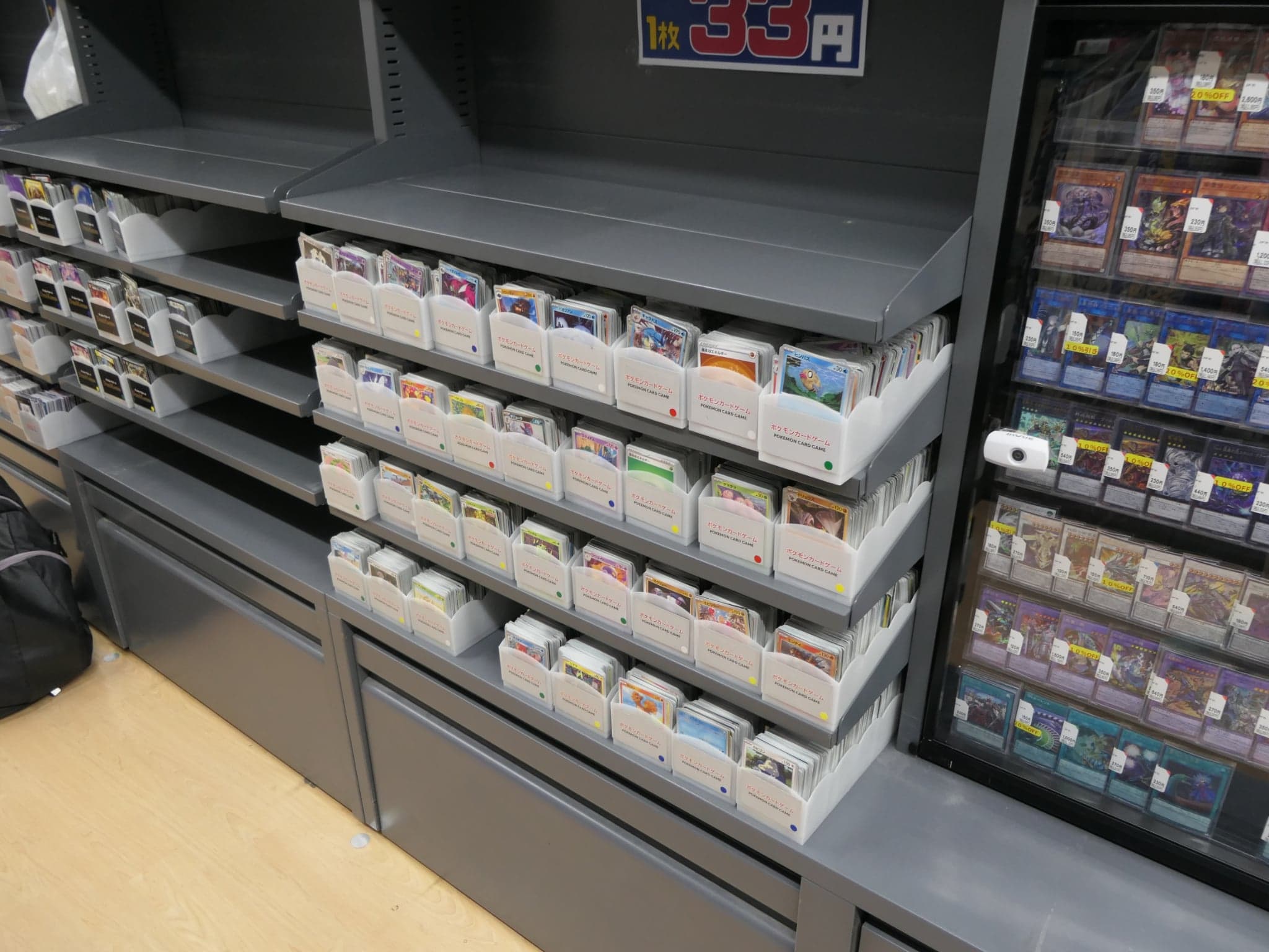 A photo of some bulk Japanese pokemon cards in a store.