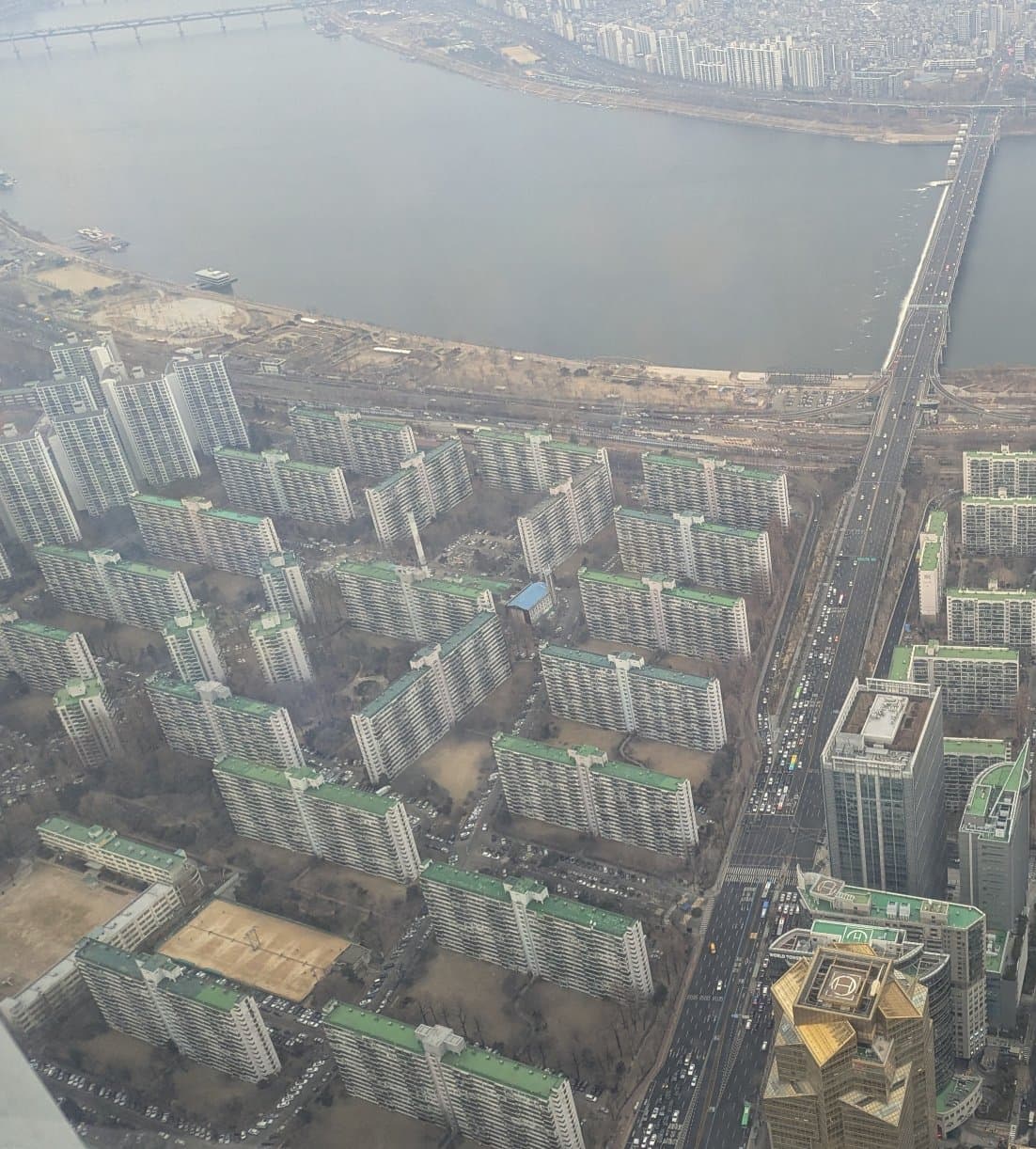 An image of a bunch of identical buildings taken from the top of the Lotte World Tower.