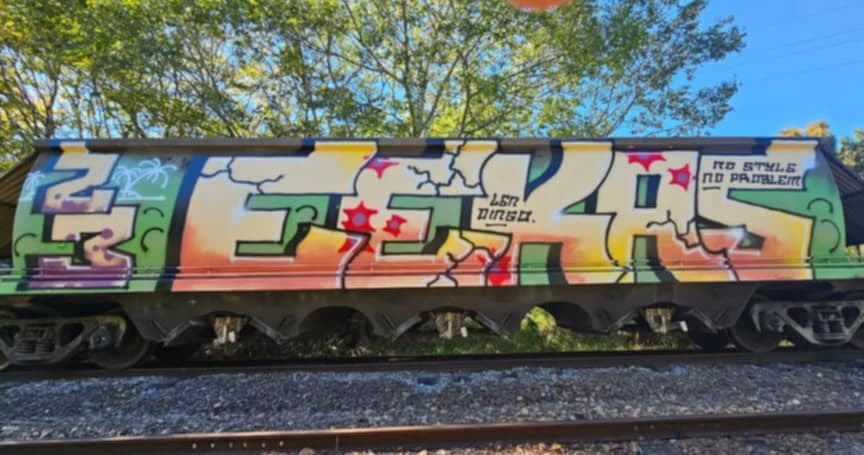 A large colourful graffiti tag saying "Eekas" on the side of a train.