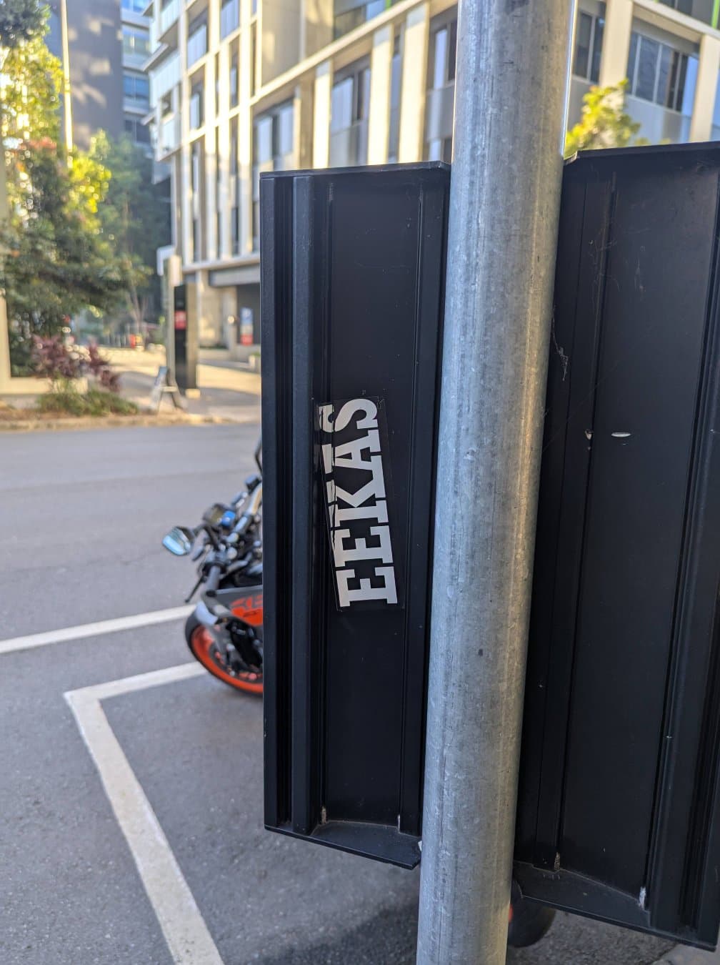 A relatively low effort Eekas sticker, stuck to the back of a bus timetable.