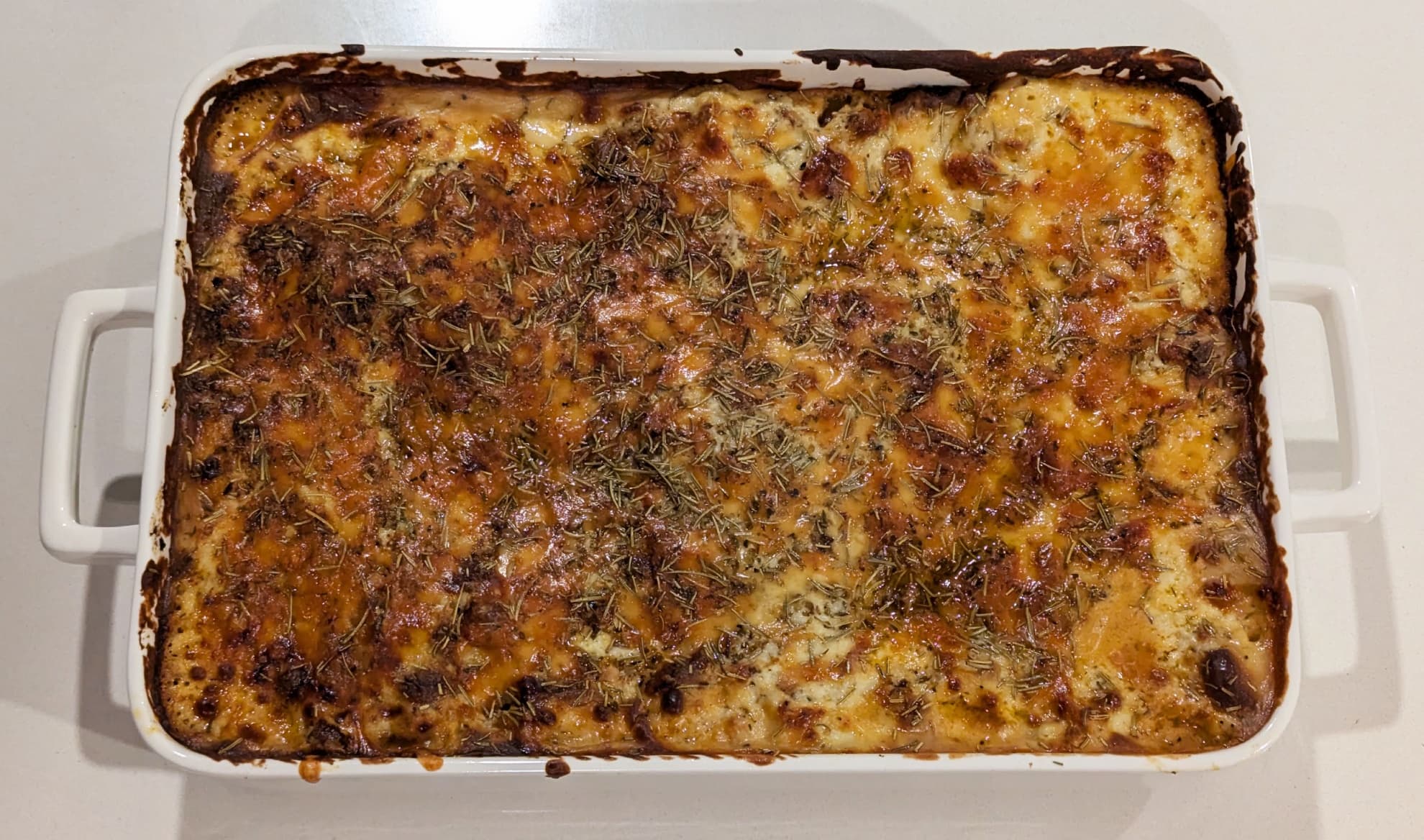 The whole cooked lasagne in a ceramic cooking dish